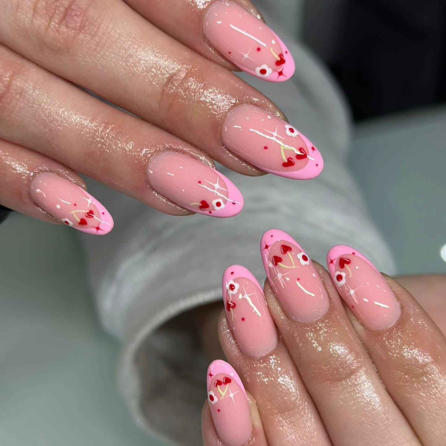 Pink French tip nails with cherry and heart nail art by Studio J, Swords