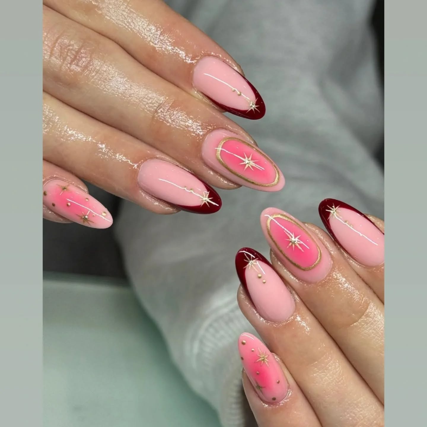 Pink and burgundy nails with gold star detailing by Studio J, Swords